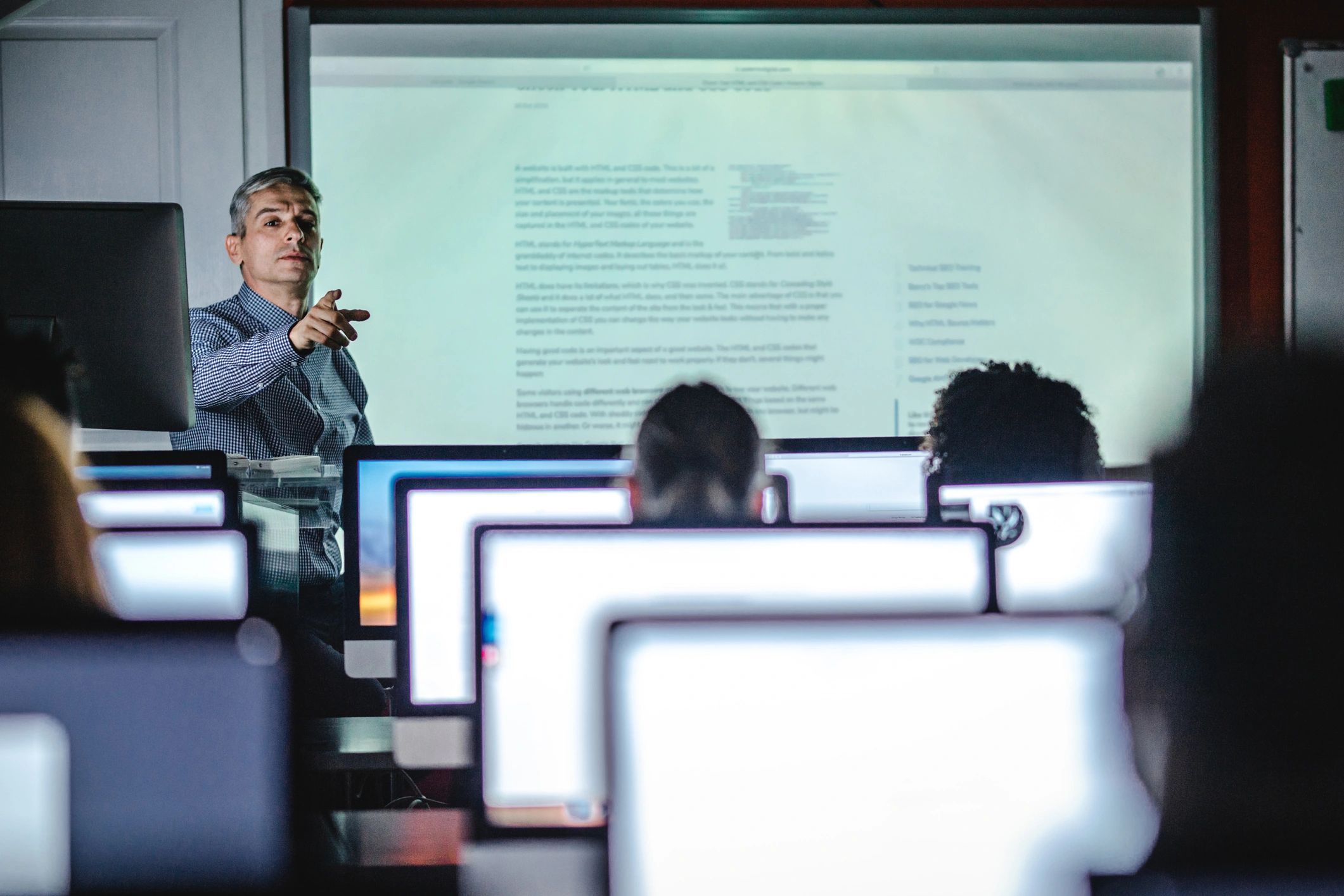 Instructor teaching a technical class in a computer lab