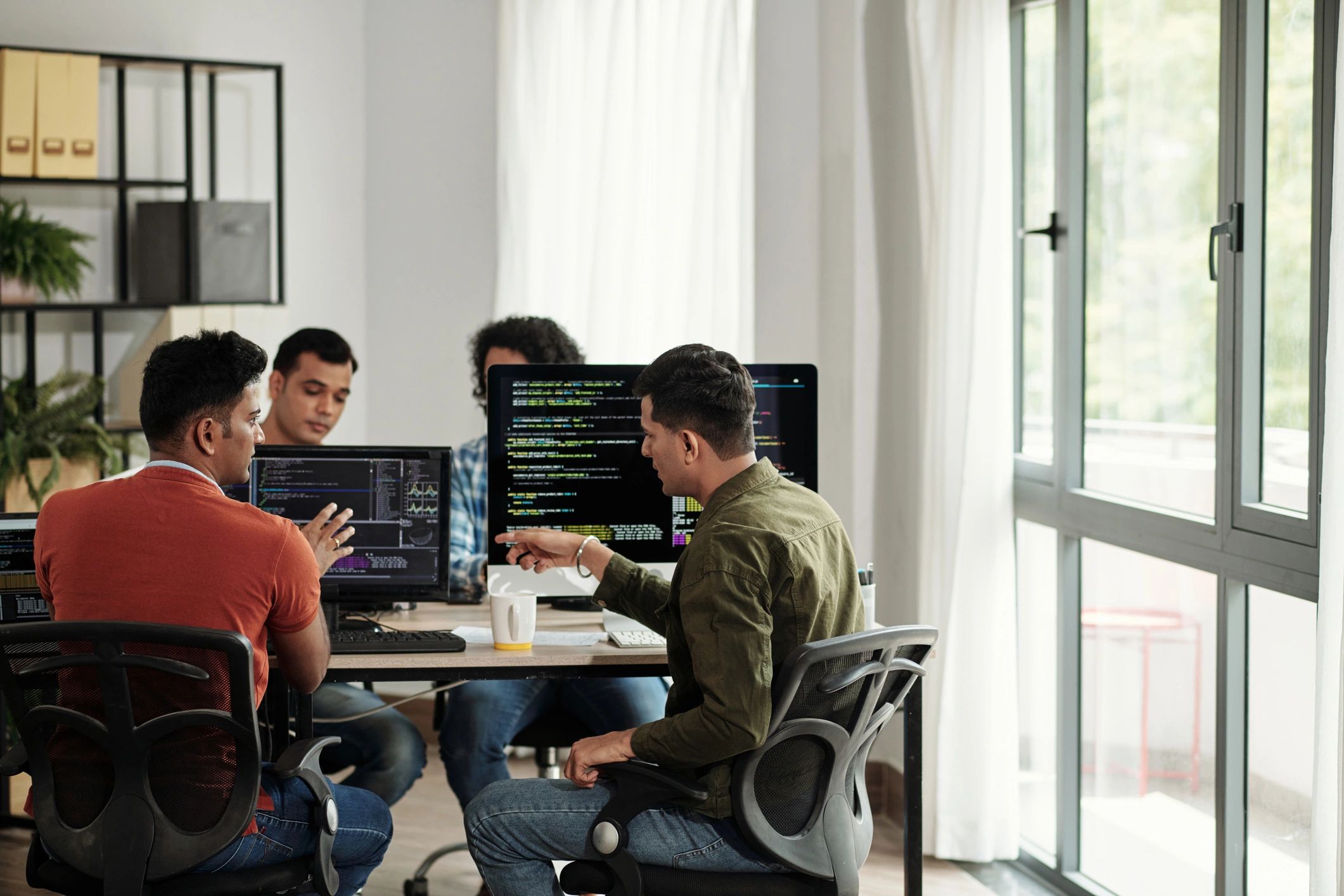 Developers reviewing code during a secure coding training session