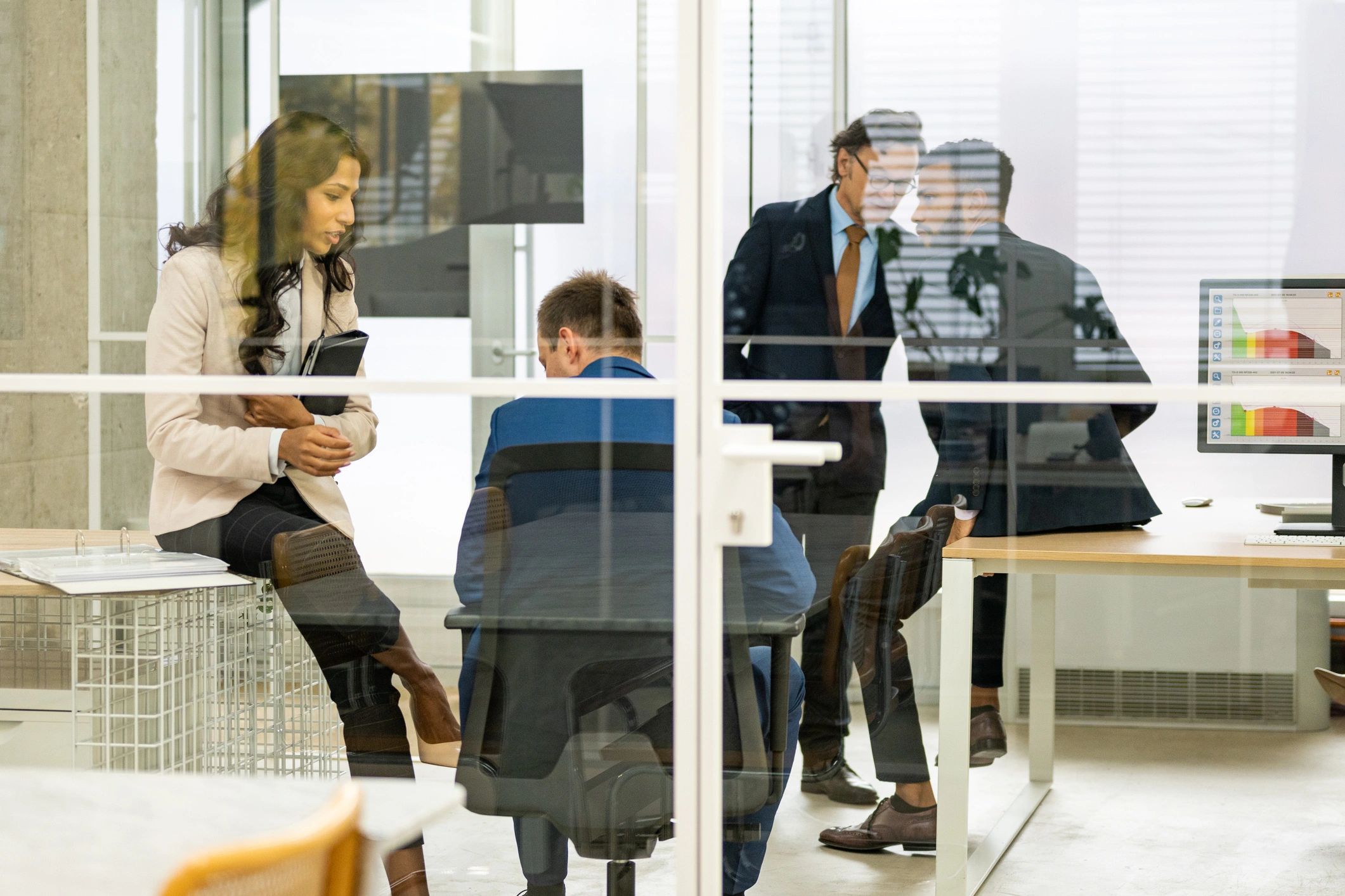 Professionals collaborating in a meeting room for training and enablement planning