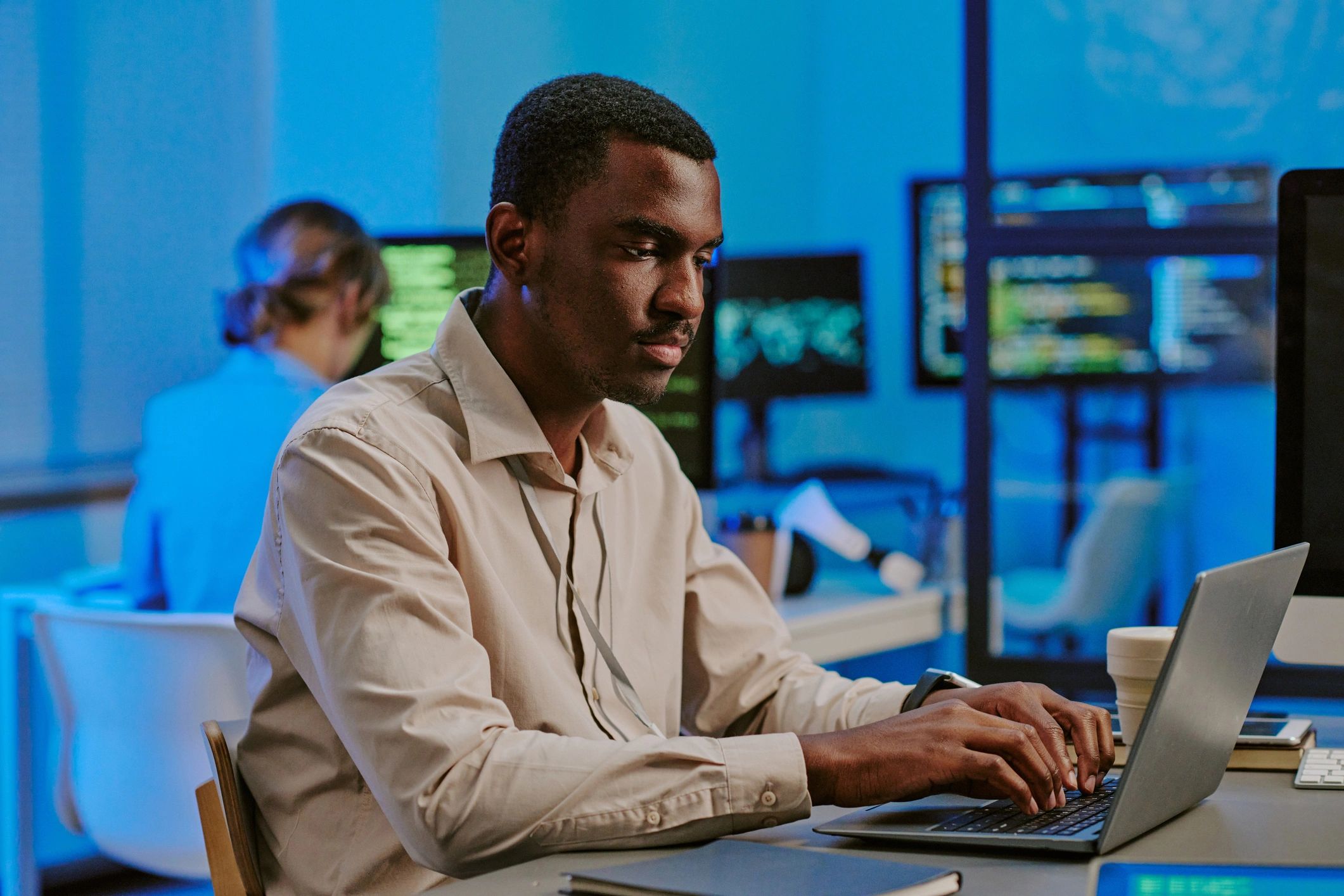 Security specialist working on a laptop reviewing telemetry