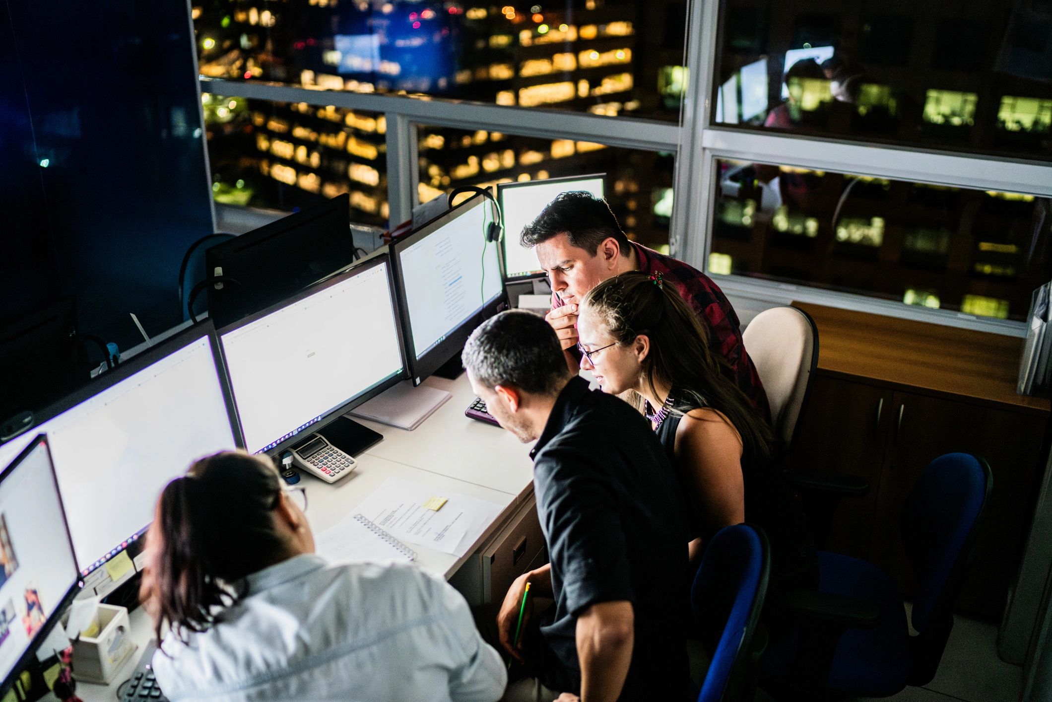 Team working together in an office representing coordinated delivery
