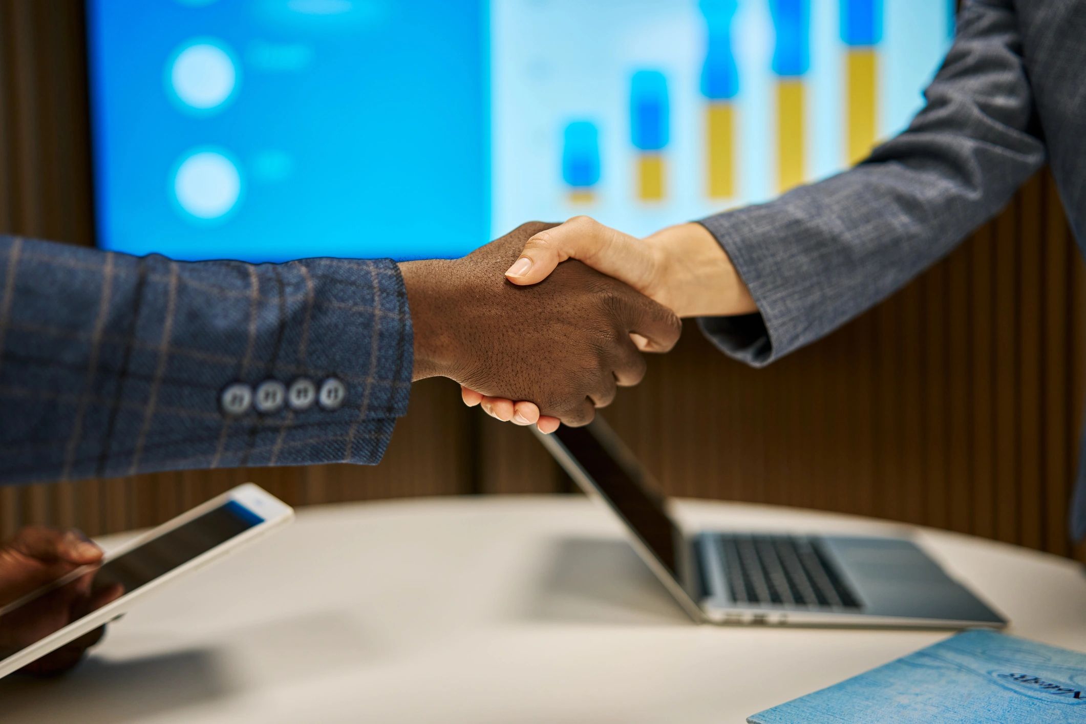 Business partners shaking hands to formalize a cybersecurity partnership