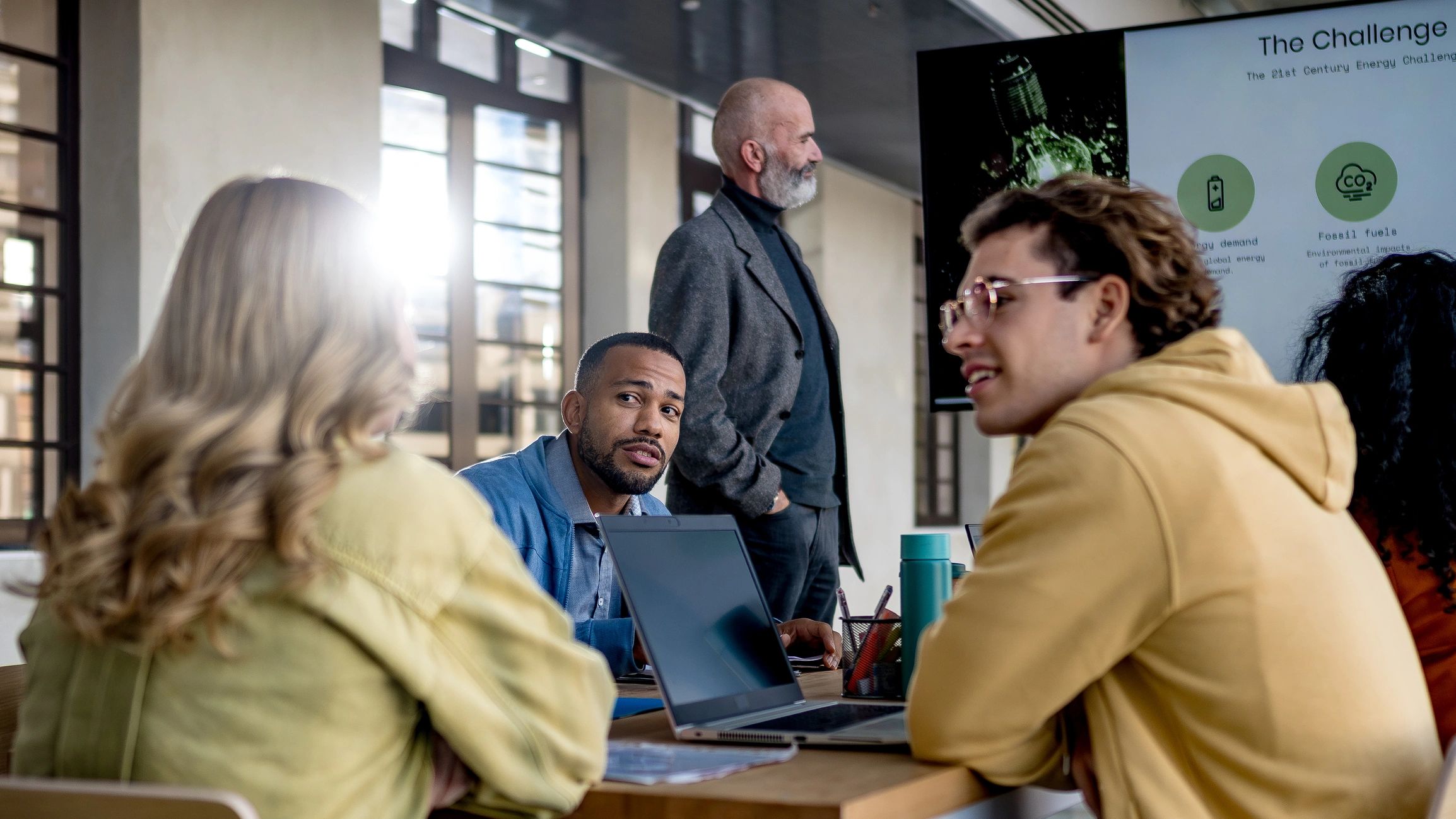 Team presenting and collaborating on a cybersecurity solution in a modern office